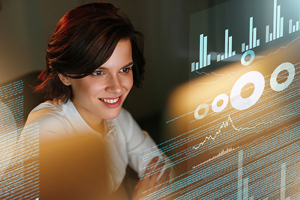 Female business woman viewing business statistics on a computer screen