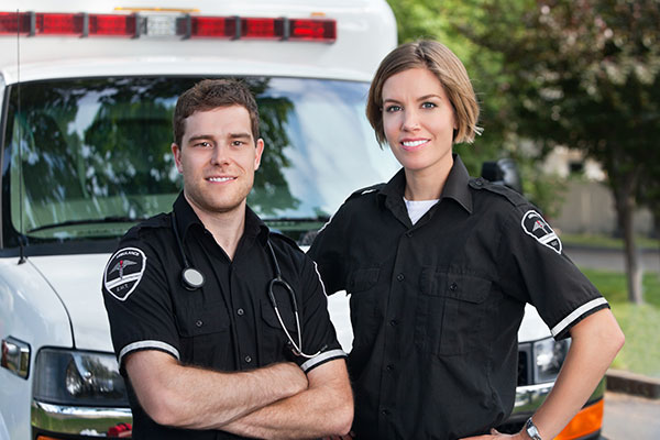 Paramedic team standing in front of ambulance