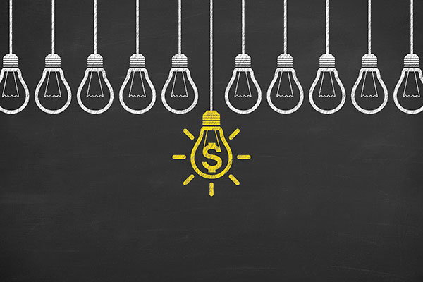 Finance idea bulb on blackboard