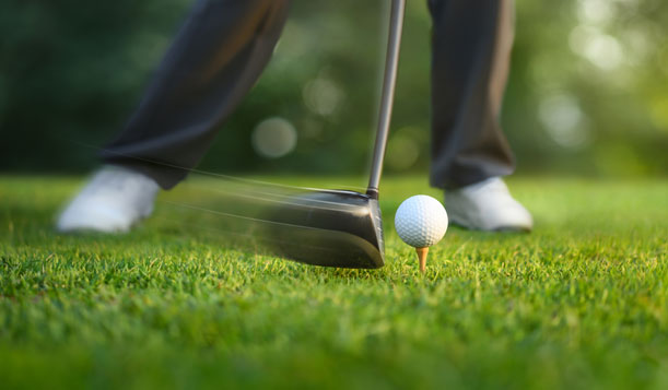 Golfer teeing off