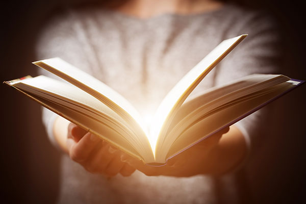 Hands holding an open book