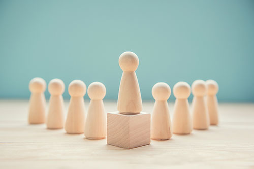 Wood person model among people on blue background