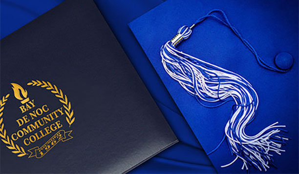 Blue graduation cap and diploma