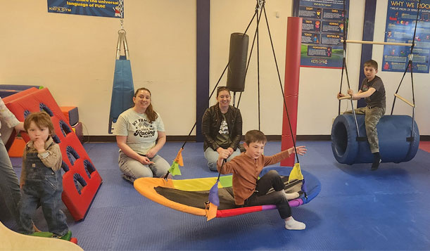 Community members playing at the Family Fun Day at We Rock the Spectrum Gym in Escanaba, MI, hosted by The Bay College Diversity Committee on April 12, 2025.