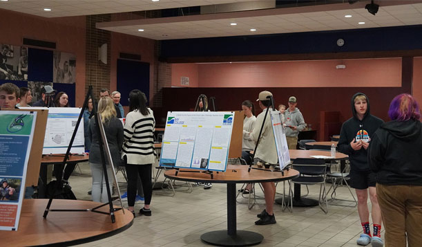 Bay College students and faculty engage in lively discussions of work showcased at the 2024 Student Poster Symposium, a celebration of collaboration, creativity, and academic achievement.