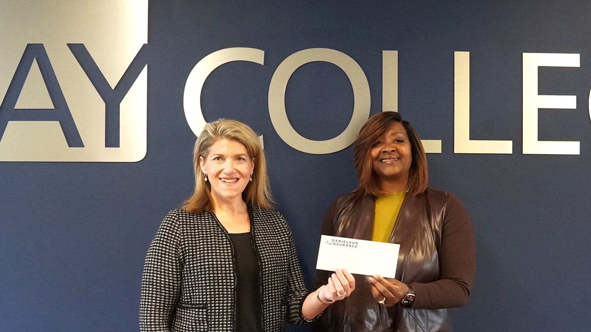 Danielson Insurance Agent, Becka Holm (left), presents a scholarship check to Dr. Nerita Hughes, President of Bay College (right), in continued support of students enrolled at the Iron Mountain Campus for the 2026 – 2027 Academic Year.